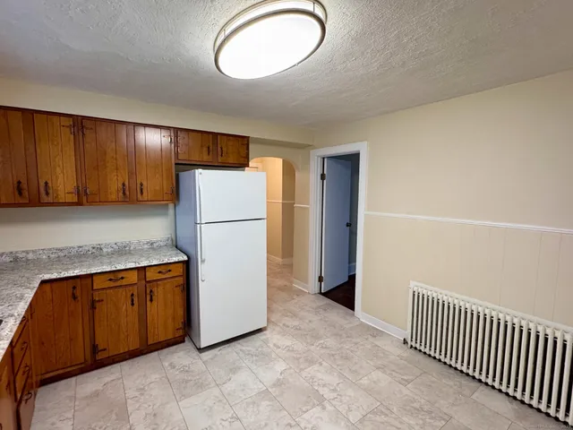a view of a kitchen with a refrigerator a microwave and a sink