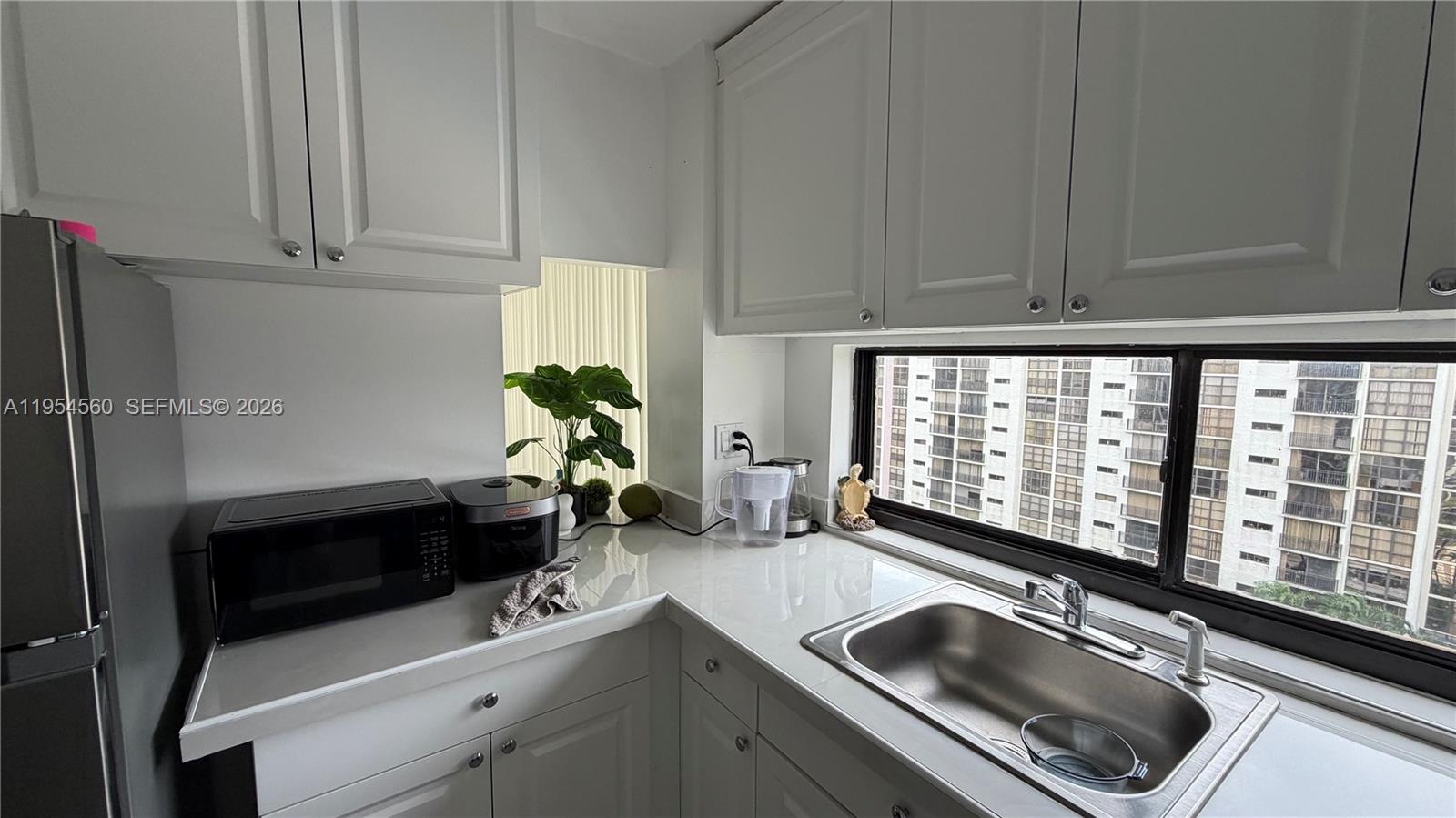 17011 North Bay Road, Unit 912 Sunny Isles Beach, FL 33160 - Photo 13 of 43 a kitchen with a sink and cabinets