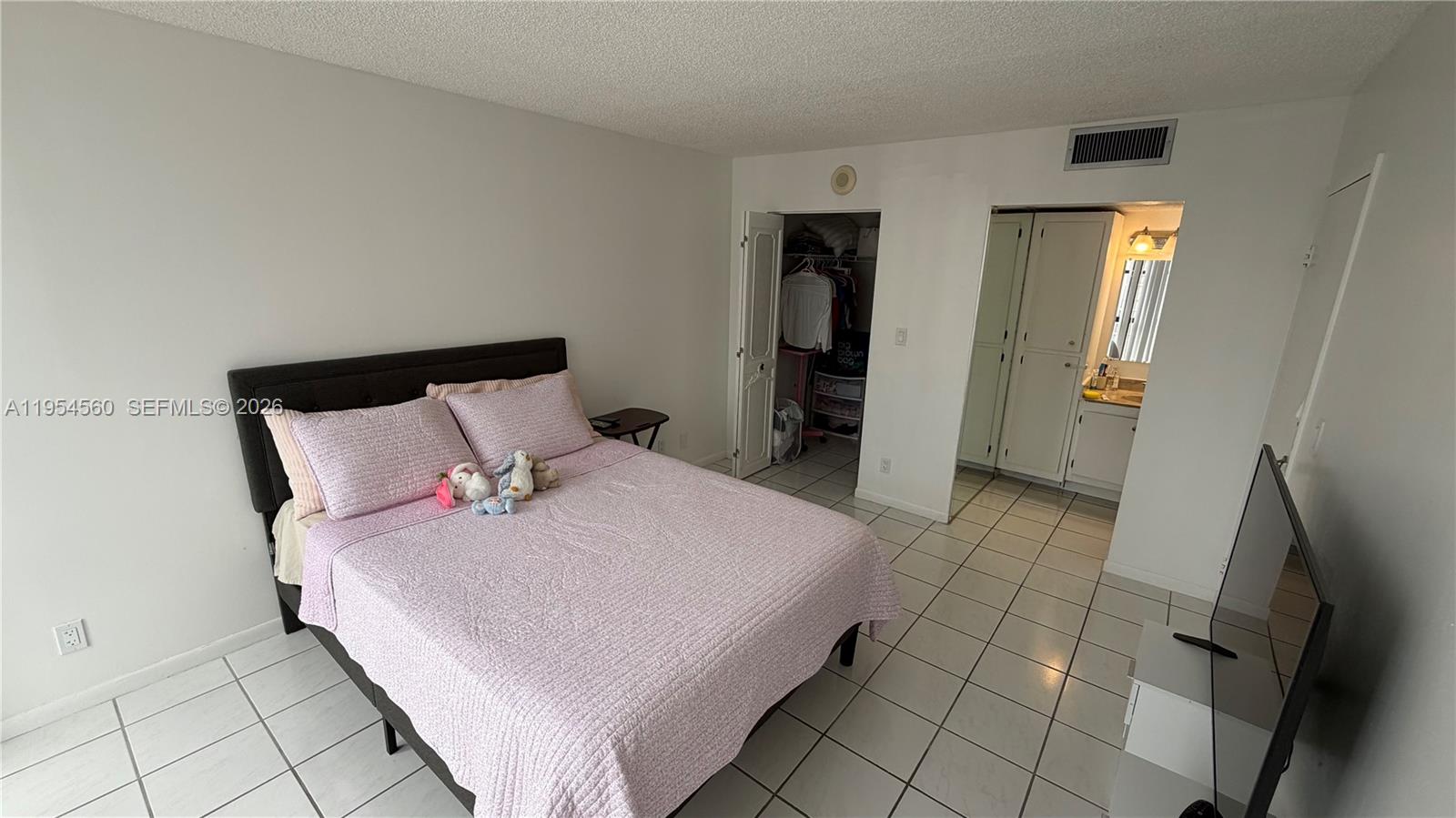 17011 North Bay Road, Unit 912 Sunny Isles Beach, FL 33160 - Photo 21 of 43 a bedroom with a bed and a rug