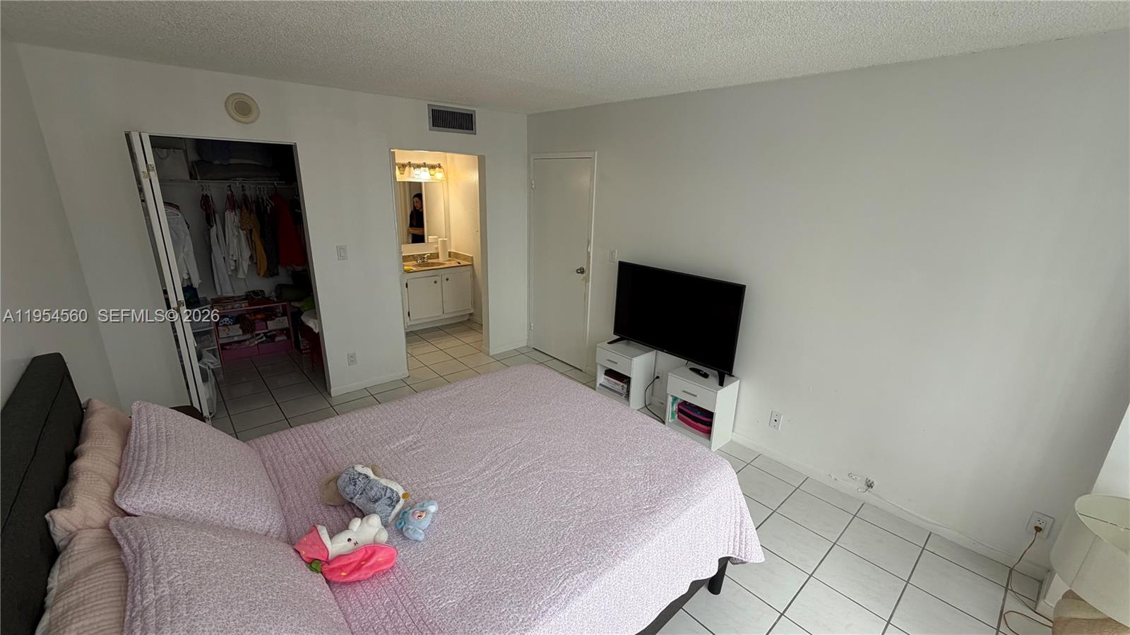 17011 North Bay Road, Unit 912 Sunny Isles Beach, FL 33160 - Photo 22 of 43 a bedroom with a bed and a flat screen tv