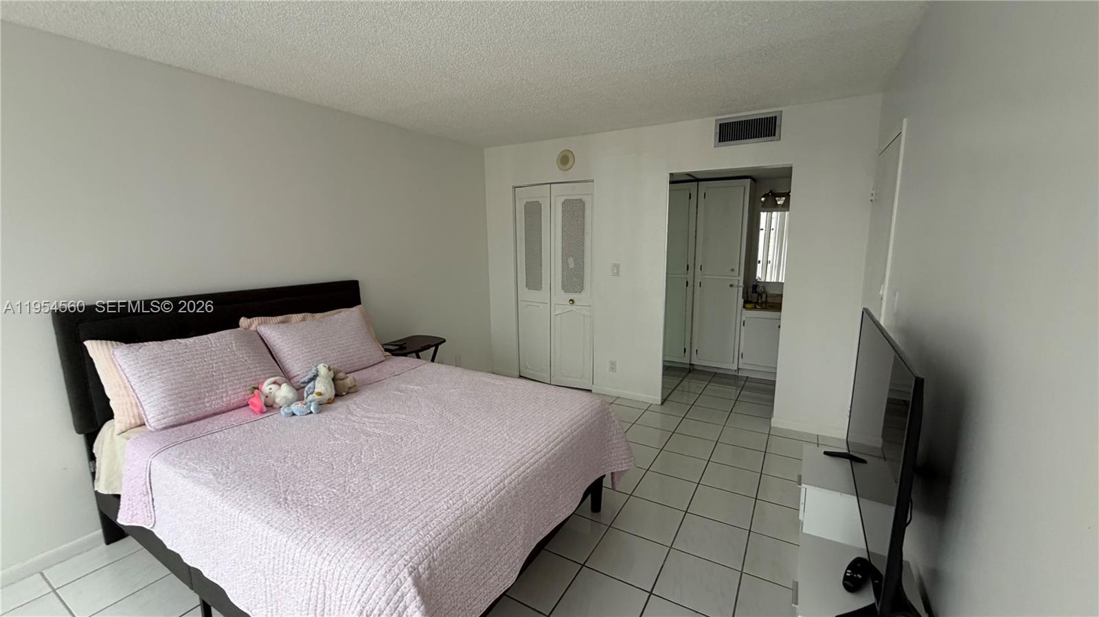 17011 North Bay Road, Unit 912 Sunny Isles Beach, FL 33160 - Photo 24 of 43 a large bed in a bedroom next to a window