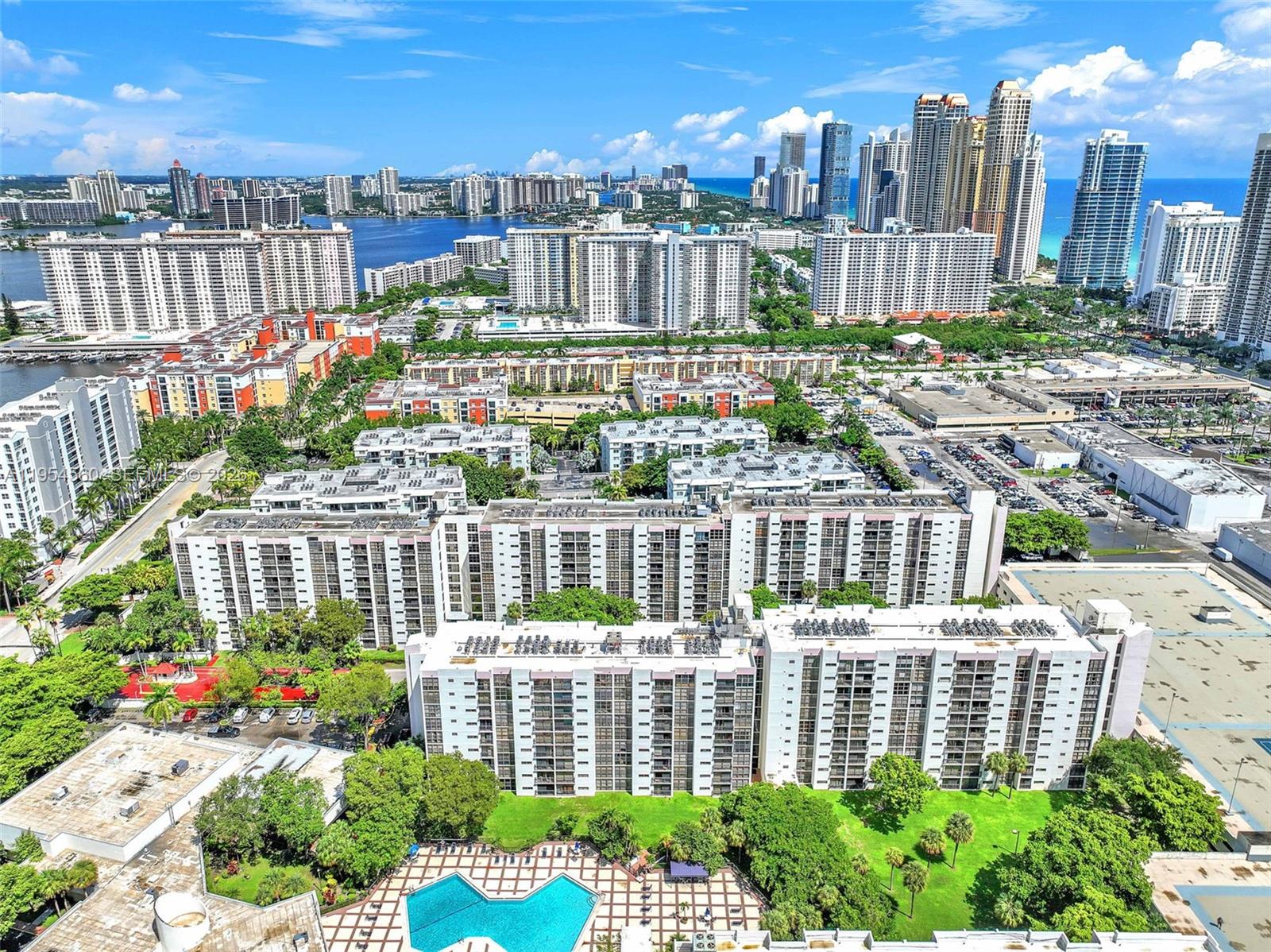 17011 North Bay Road, Unit 912 Sunny Isles Beach, FL 33160 - Photo 39 of 43 a view of a city with tall buildings and a bench