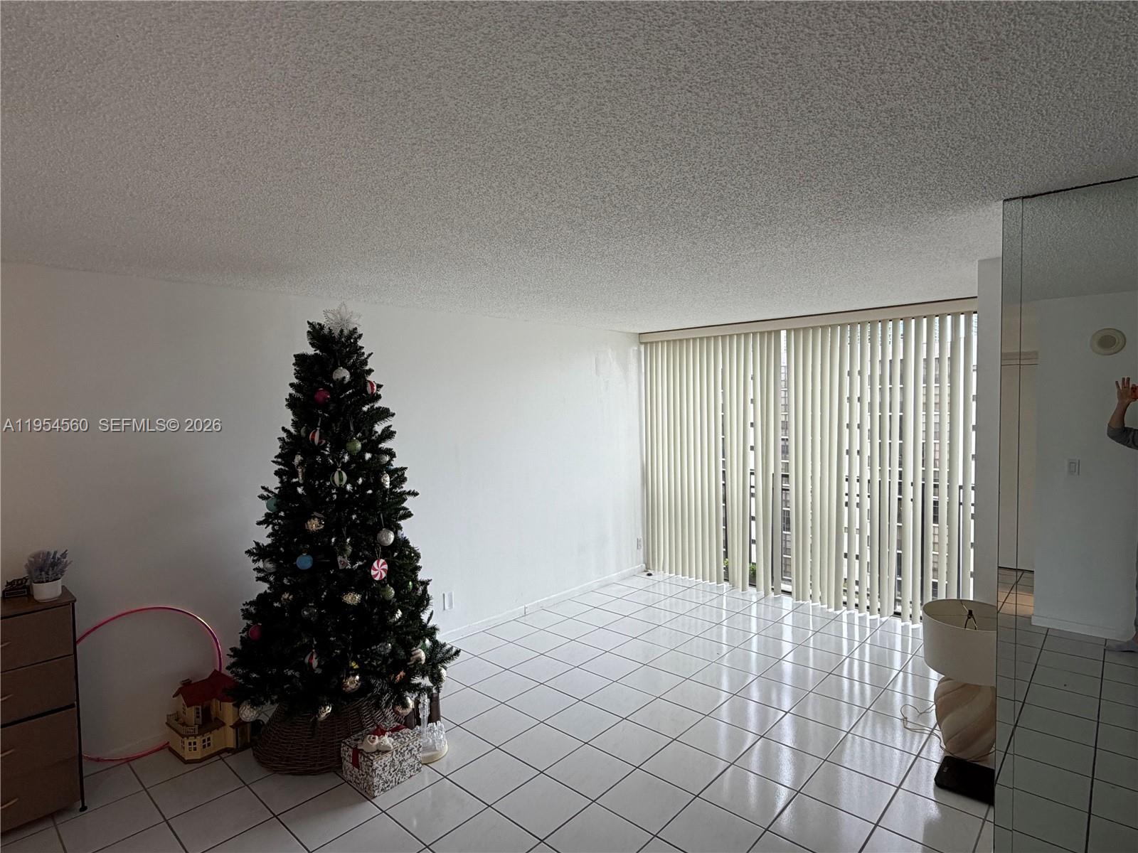17011 North Bay Road, Unit 912 Sunny Isles Beach, FL 33160 - Photo 4 of 43 a bedroom with a bed and a window