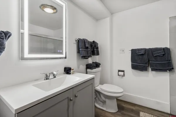 a bathroom with a toilet sink and mirror