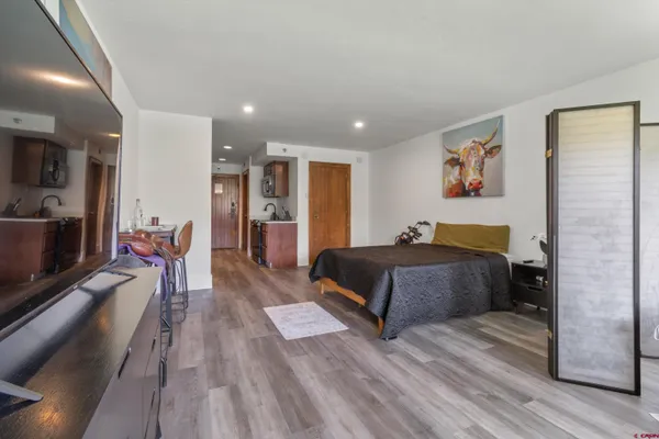 a bedroom with a large bed and a chandelier