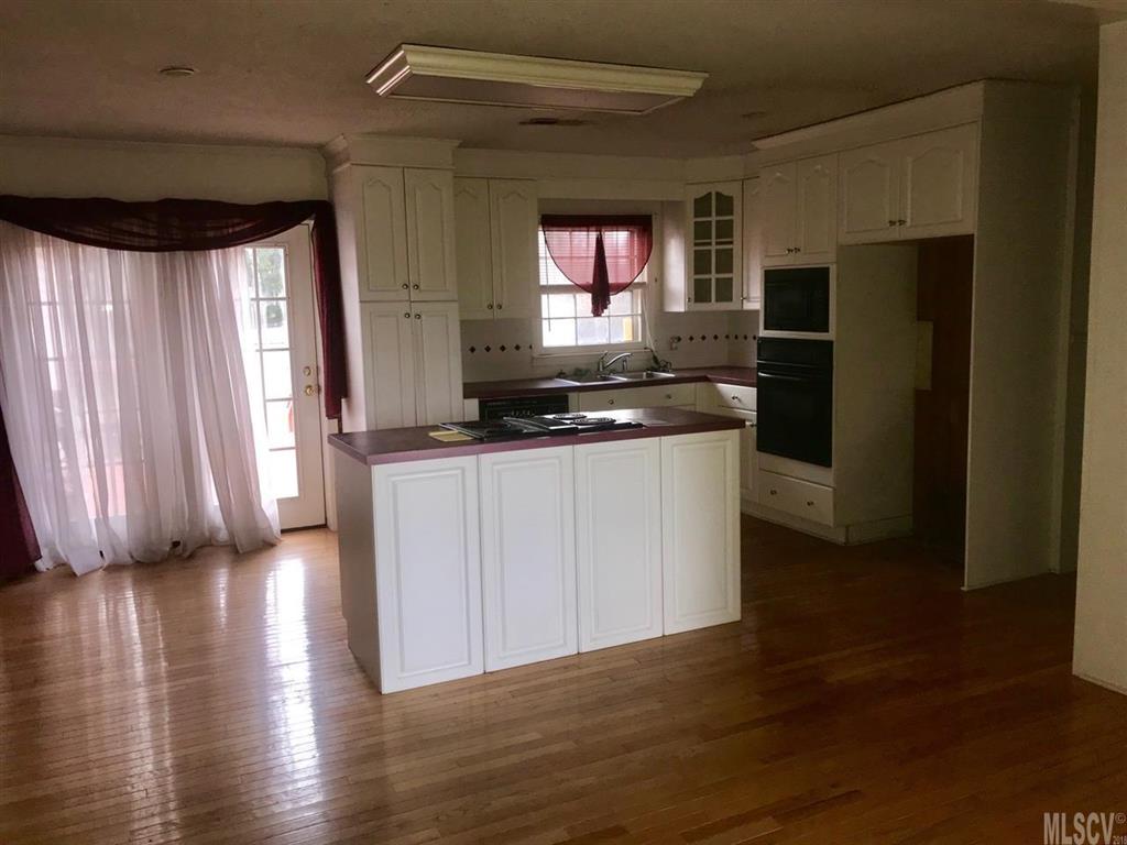 316 York Road Stony Point, NC 28678 - Photo 10 of 15 a kitchen with stainless steel appliances granite countertop a refrigerator a sink a stove a microwave and island with wooden floor