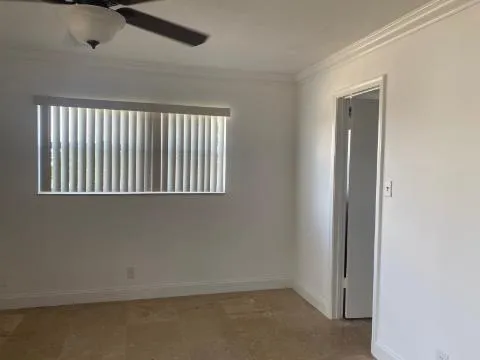a room with pool table and windows