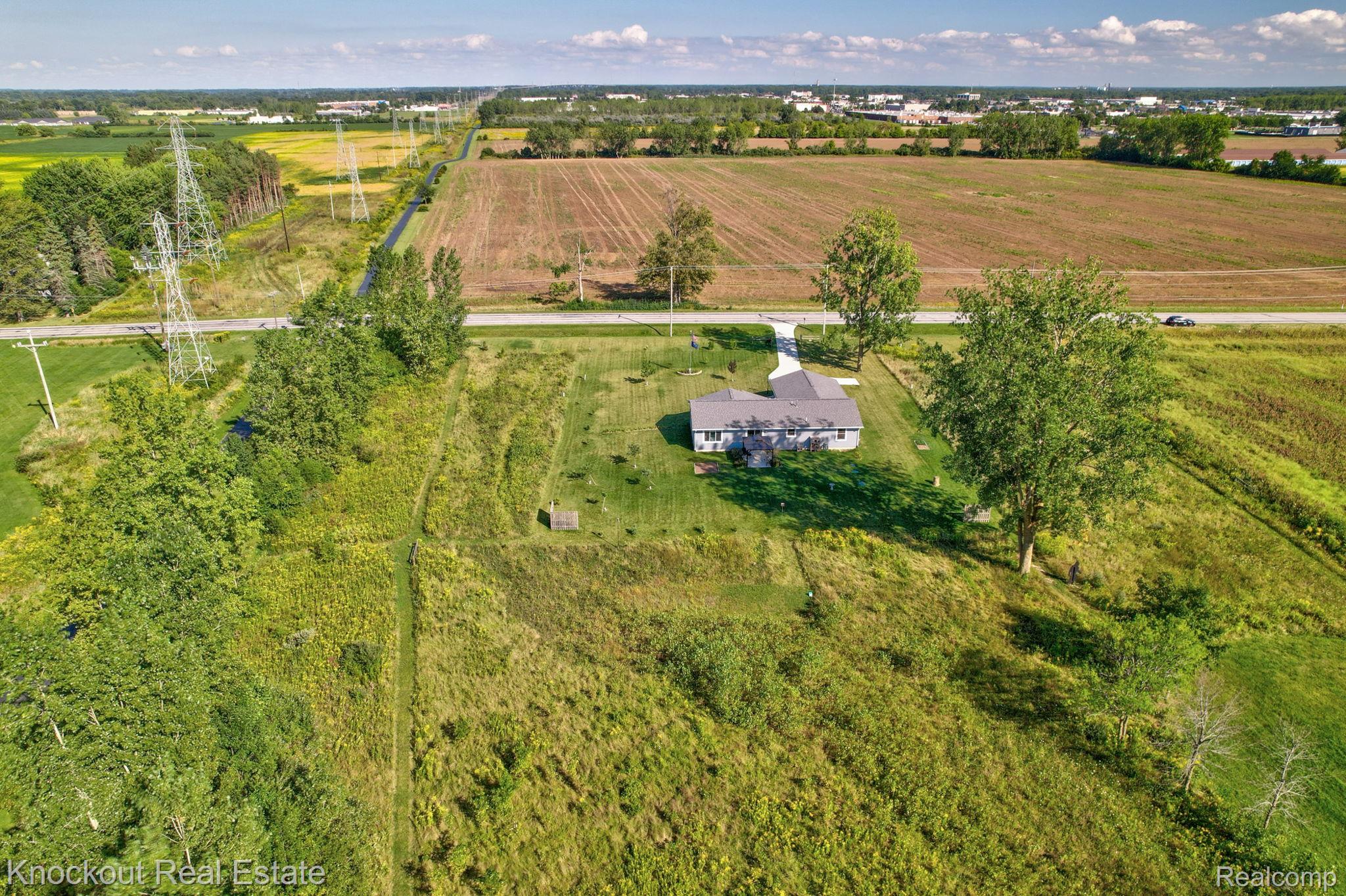 5727 Mackinaw Road Saginaw, MI 48604 - Photo 55 of 60 Single-story residence set on a large lot with mature trees, surrounded by expansive agricultural fields