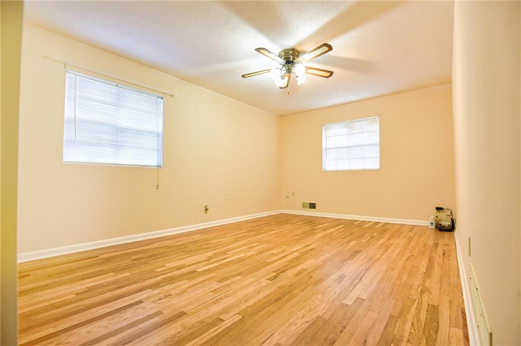 6418 Maddox Road Morrow, GA 30260 - Photo 18 of 30 a view of an empty room with wooden floor and a window