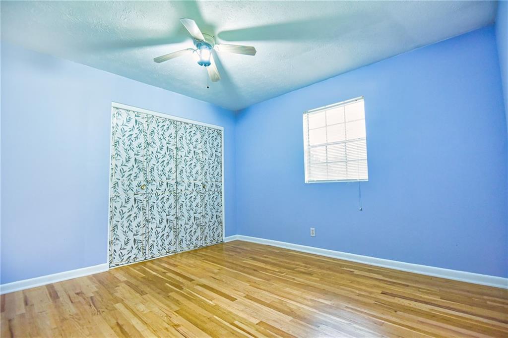 6418 Maddox Road Morrow, GA 30260 - Photo 21 of 30 a view of a bedroom with a bed and a chandelier fan