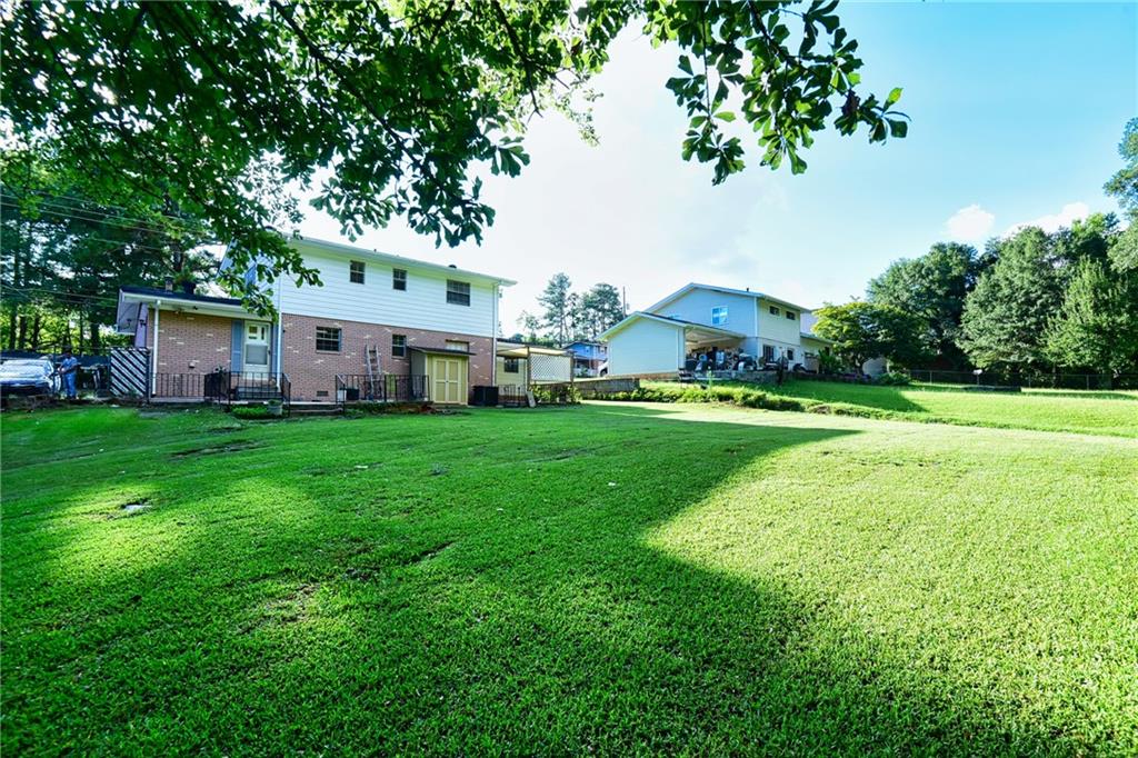 6418 Maddox Road Morrow, GA 30260 - Photo 30 of 30 a view of a white house with a big yard and large trees