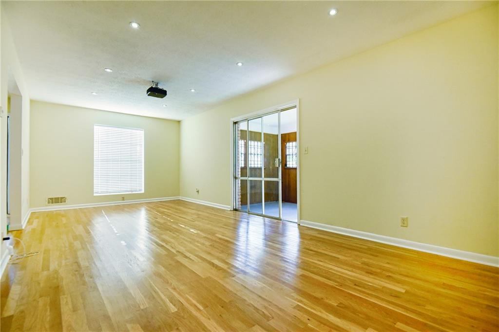6418 Maddox Road Morrow, GA 30260 - Photo 8 of 30 an empty room with wooden floor and windows