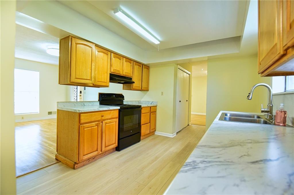 6418 Maddox Road Morrow, GA 30260 - Photo 10 of 30 a kitchen with stainless steel appliances granite countertop a stove a sink and a microwave