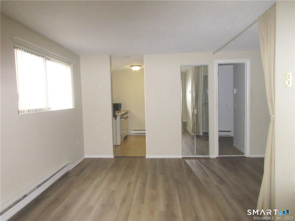 5 Nabby Road, Unit A51 Danbury, CT 06811 - Photo 2 of 13 a view of a room with wooden floor and a window