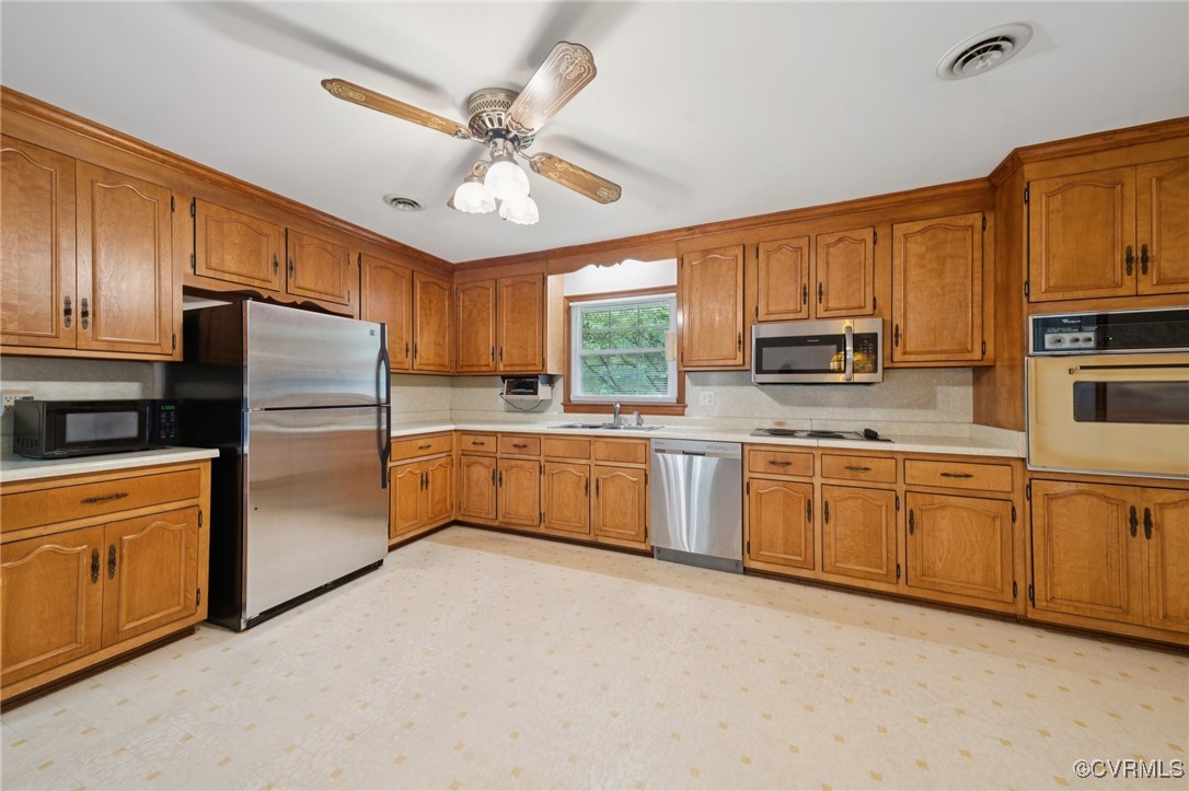 8410 Beach Road Chesterfield, VA 23838 - Photo 3 of 22 a kitchen with stainless steel appliances granite countertop a refrigerator a stove top oven a sink dishwasher and white cabinets