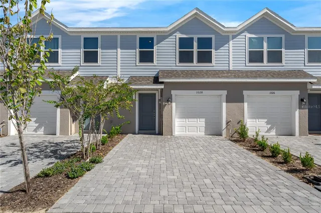 a front view of a house with a garden and plants