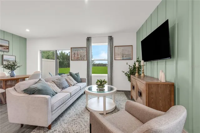 a living room with furniture and a potted plant