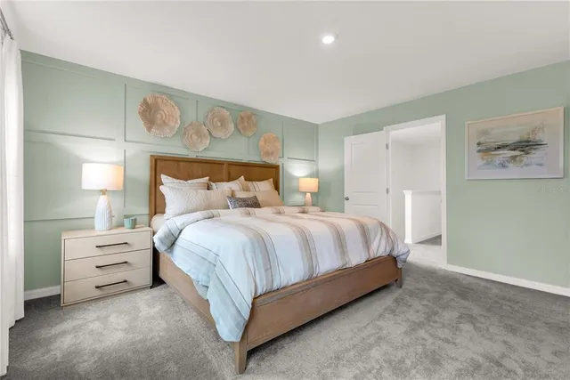 a spacious bedroom with a bed and dresser