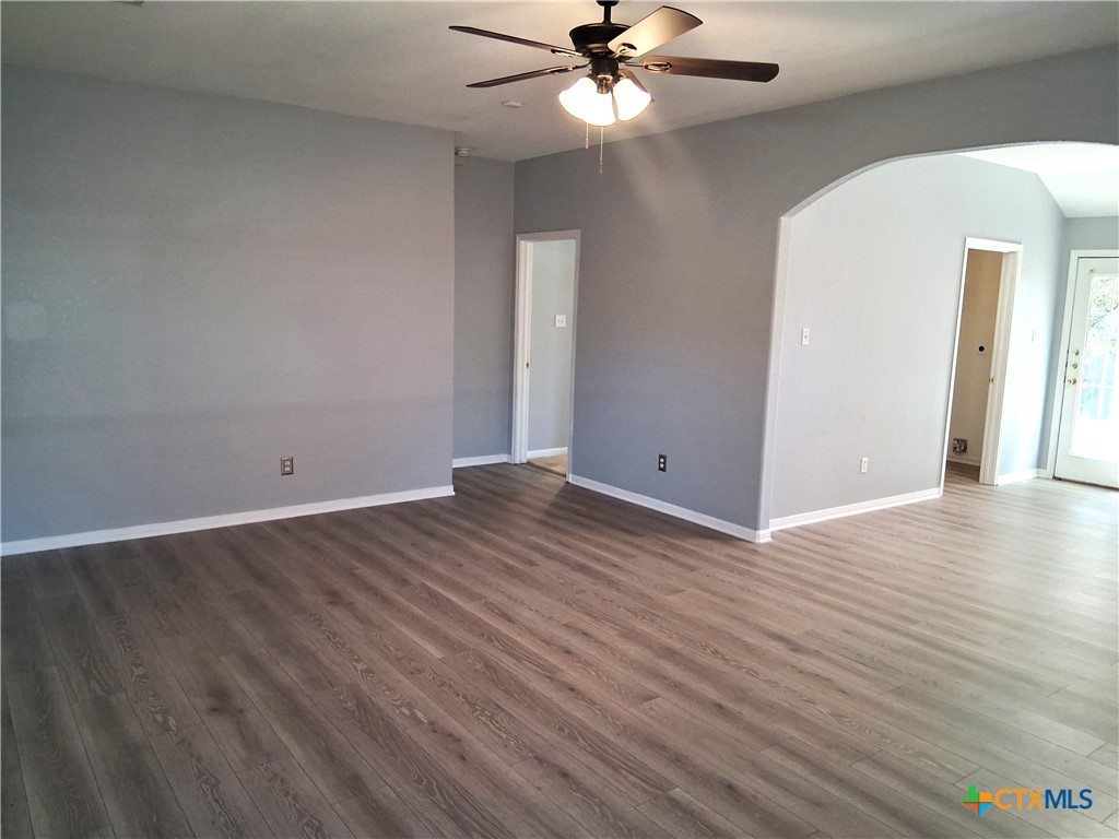 5605 Bald Ridge Court Killeen, TX 76542 - Photo 6 of 17 an empty room with wooden floor fan and windows