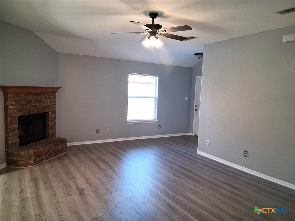 5605 Bald Ridge Court Killeen, TX 76542 - Photo 7 of 17 an empty room with windows and a fireplace