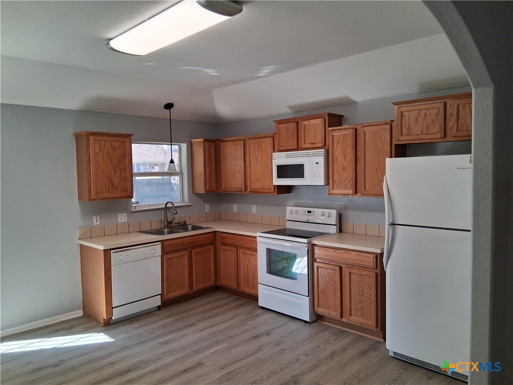 5605 Bald Ridge Court Killeen, TX 76542 - Photo 9 of 17 a kitchen with stainless steel appliances granite countertop a sink stove and refrigerator