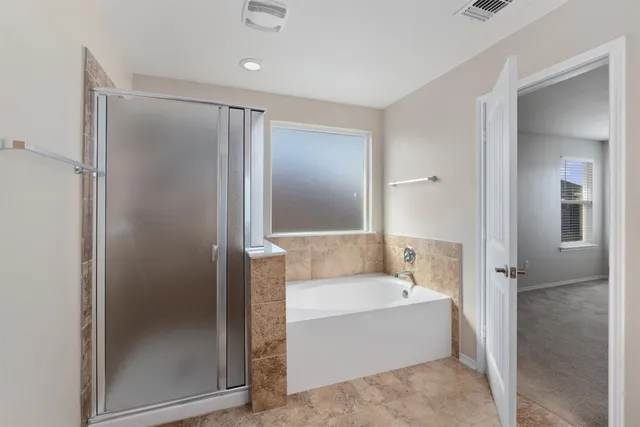 a bathroom with a tub shower and sink