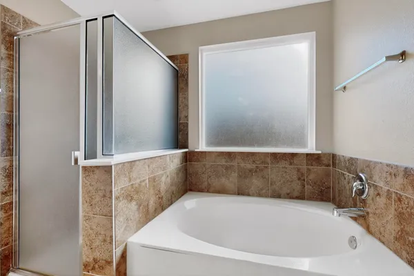 a bathroom with a bathtub and a shower