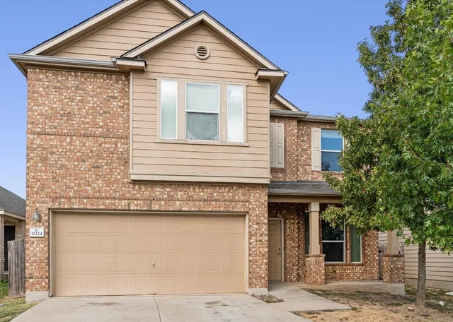 a front view of a house with a garage