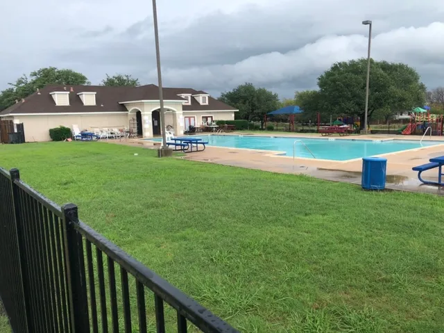 a view of outdoor space with signage and tree