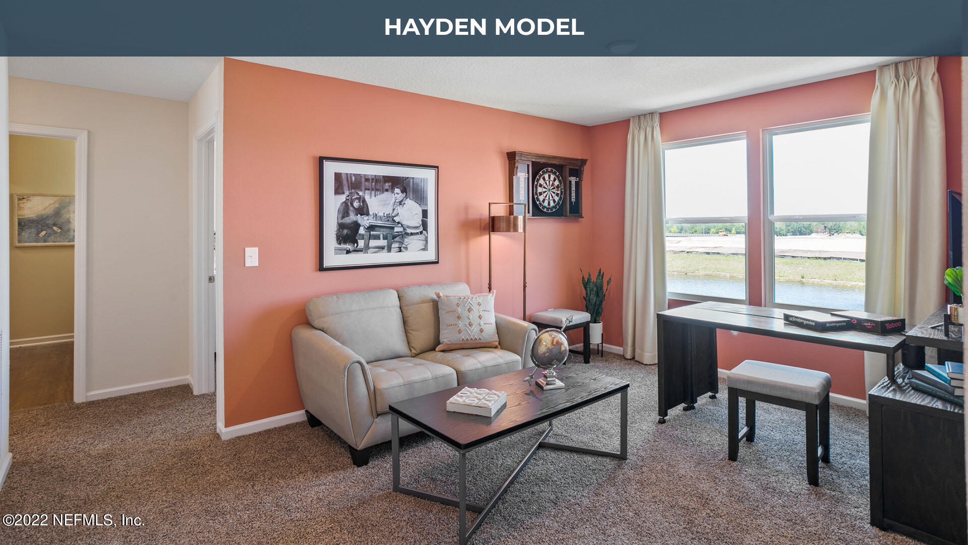 187 Encanto Way Street St. Augustine, FL 32084 - Photo 17 of 47 a living room with furniture a large window and a flat screen tv