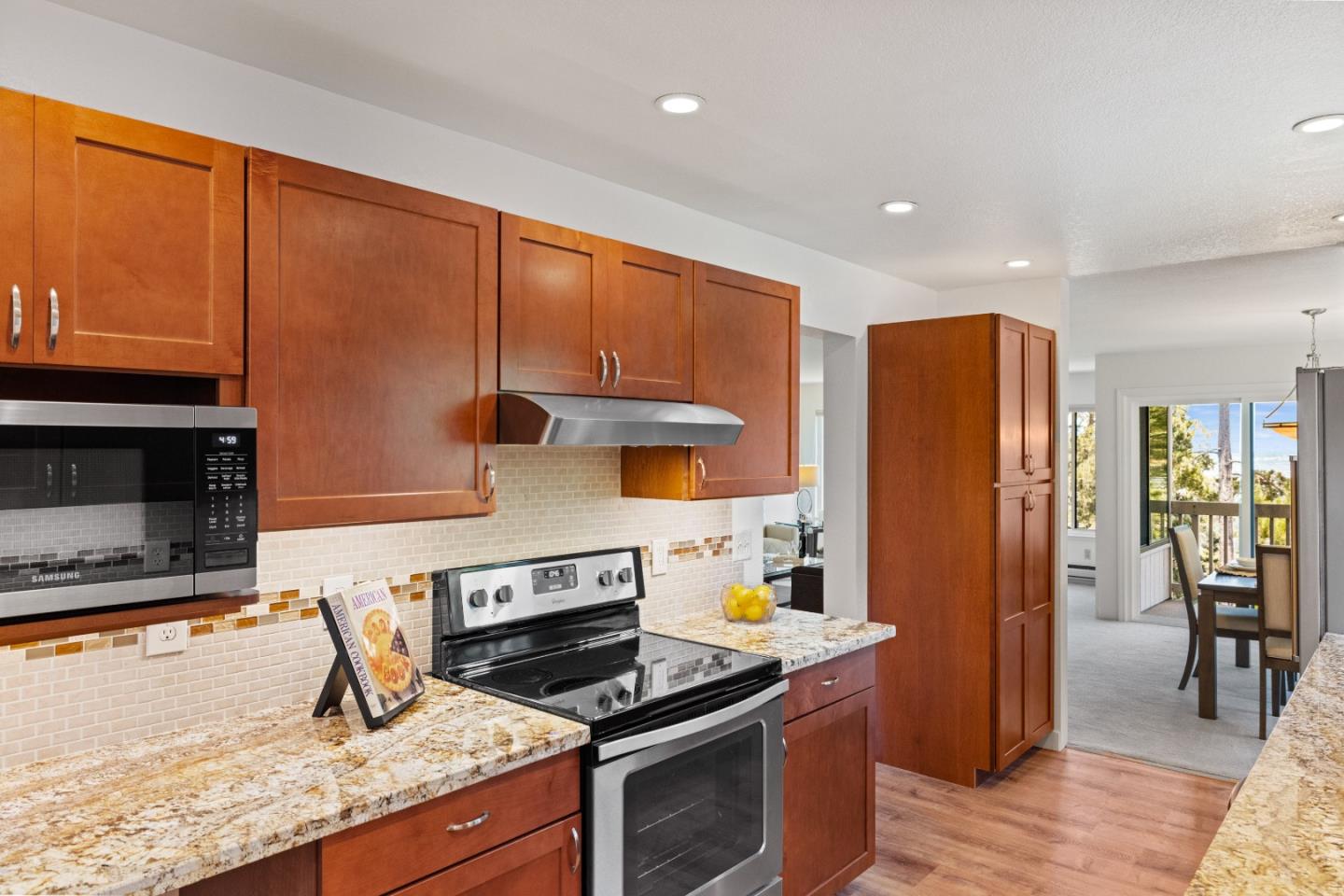 43 Shepherd's Knoll Pebble Beach, CA 93953 - Photo 14 of 34 a kitchen with stainless steel appliances granite countertop a stove a refrigerator and a microwave