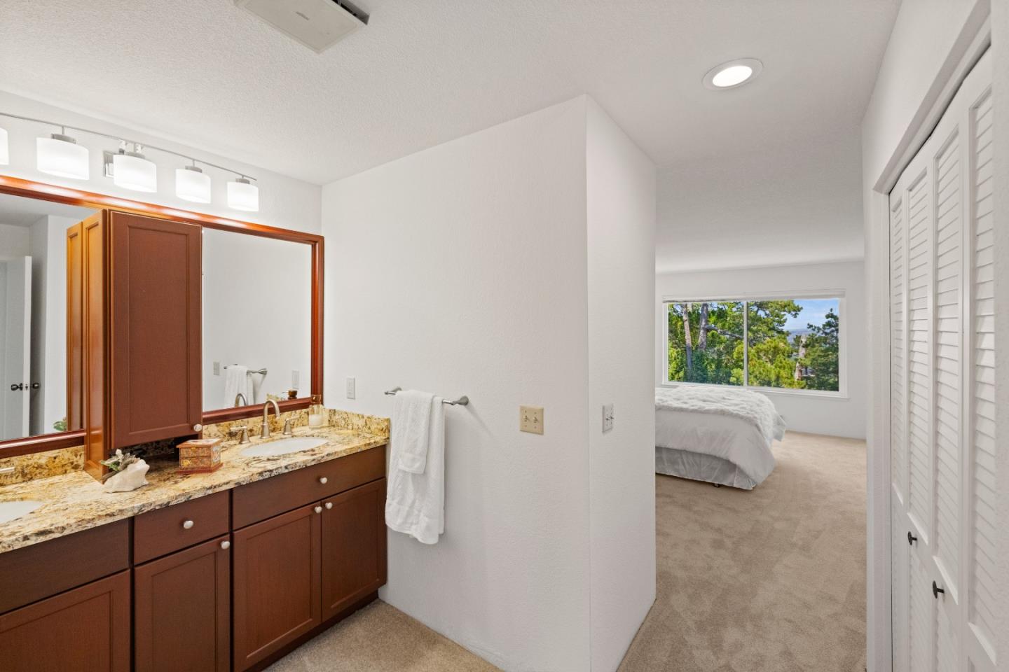 43 Shepherd's Knoll Pebble Beach, CA 93953 - Photo 21 of 34 a bathroom with a double vanity sink and mirror