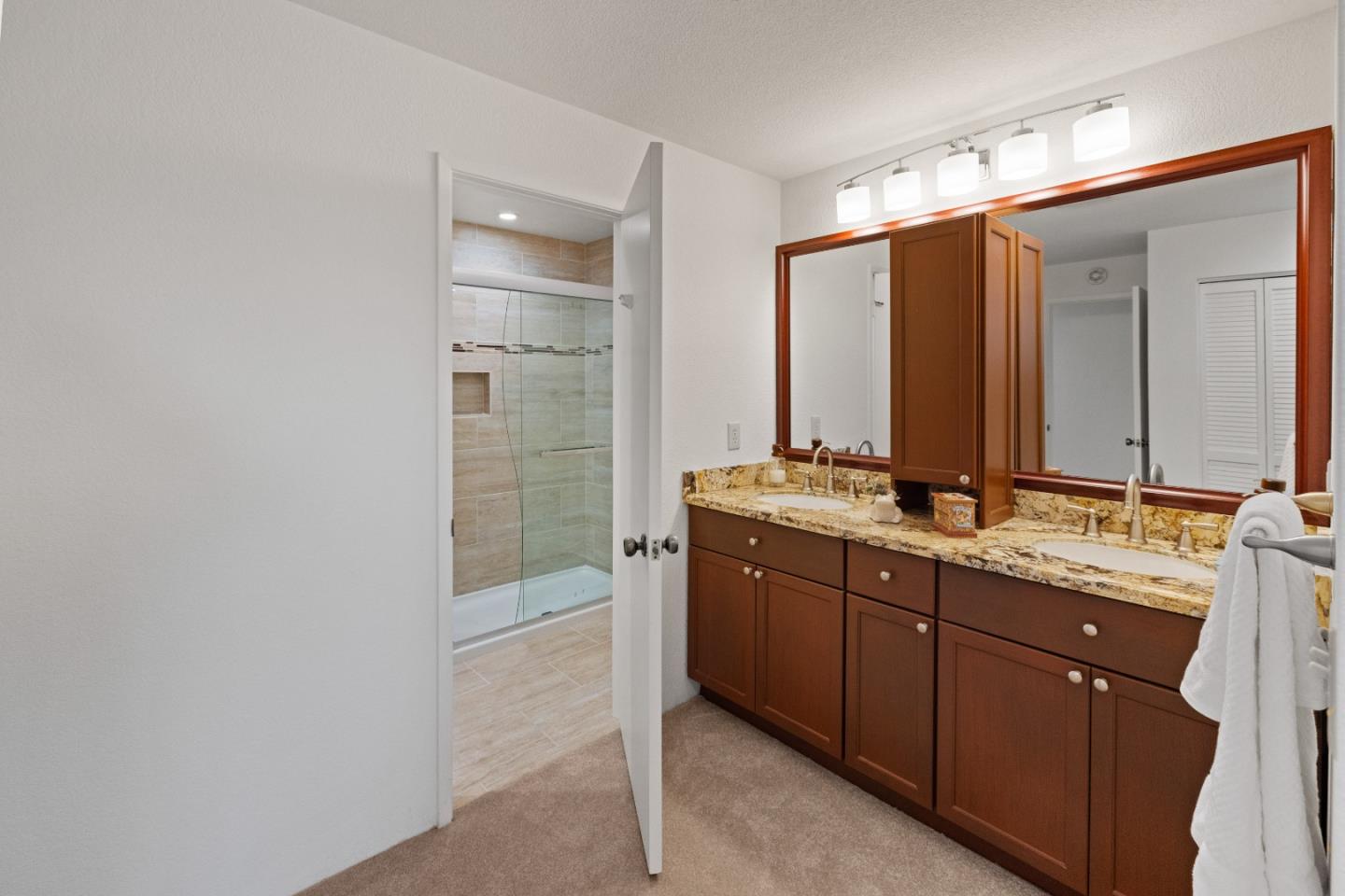 43 Shepherd's Knoll Pebble Beach, CA 93953 - Photo 23 of 34 a bathroom with a double vanity sink and mirror