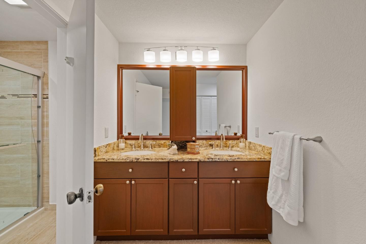 43 Shepherd's Knoll Pebble Beach, CA 93953 - Photo 24 of 34 a bathroom with a double vanity sink and mirror