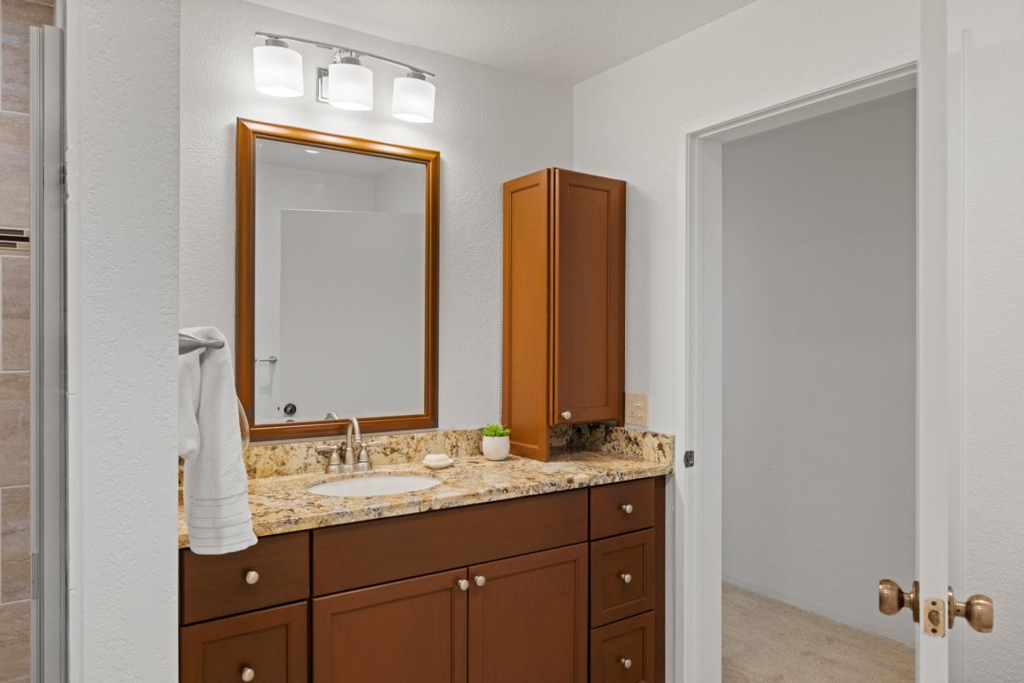 43 Shepherd's Knoll Pebble Beach, CA 93953 - Photo 28 of 34 a bathroom with a granite countertop sink and a mirror