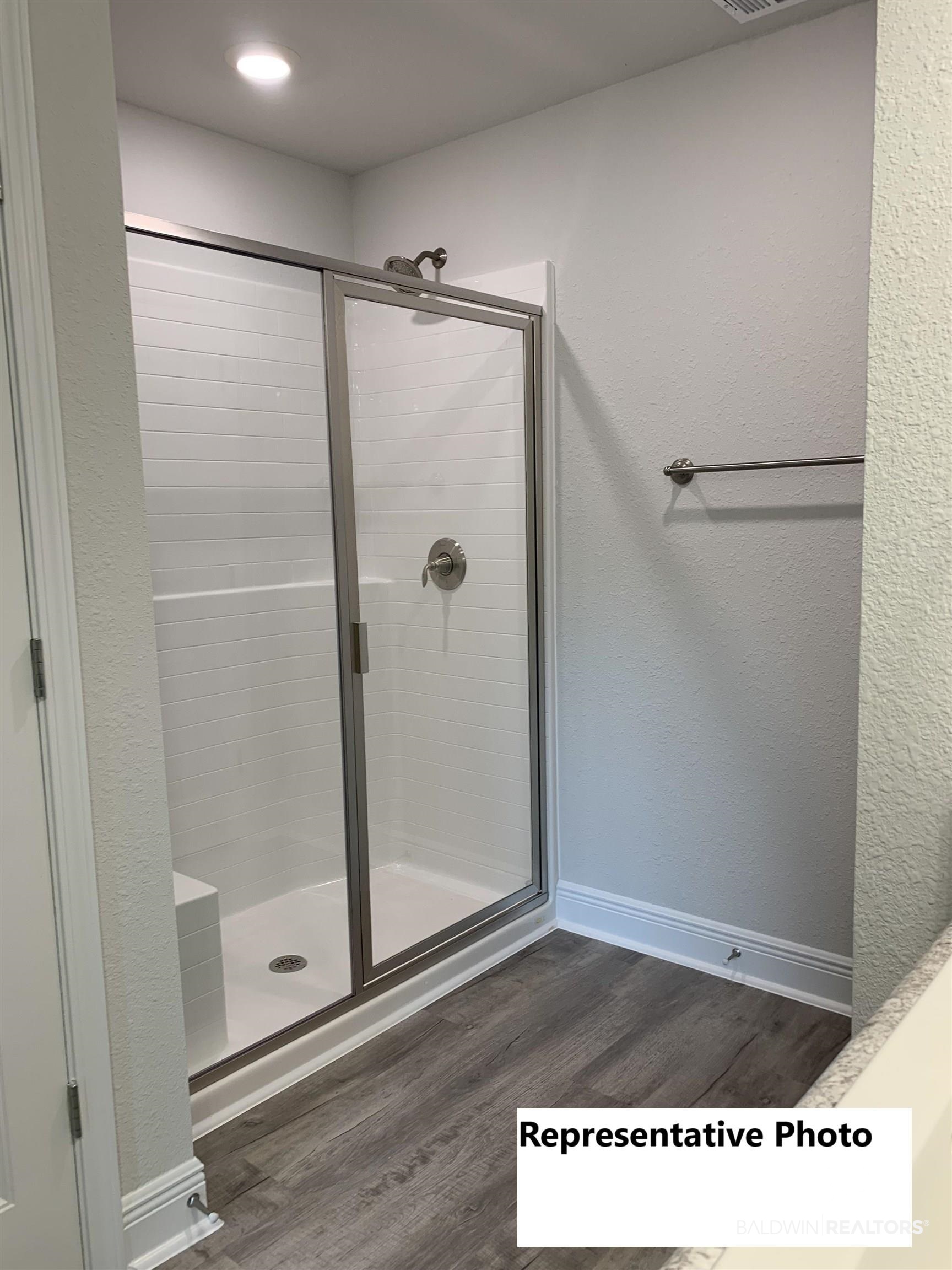 645 Revere Street Foley, AL 36535 - Photo 12 of 14 Bathroom featuring a shower with door and hardwood / wood-style floors