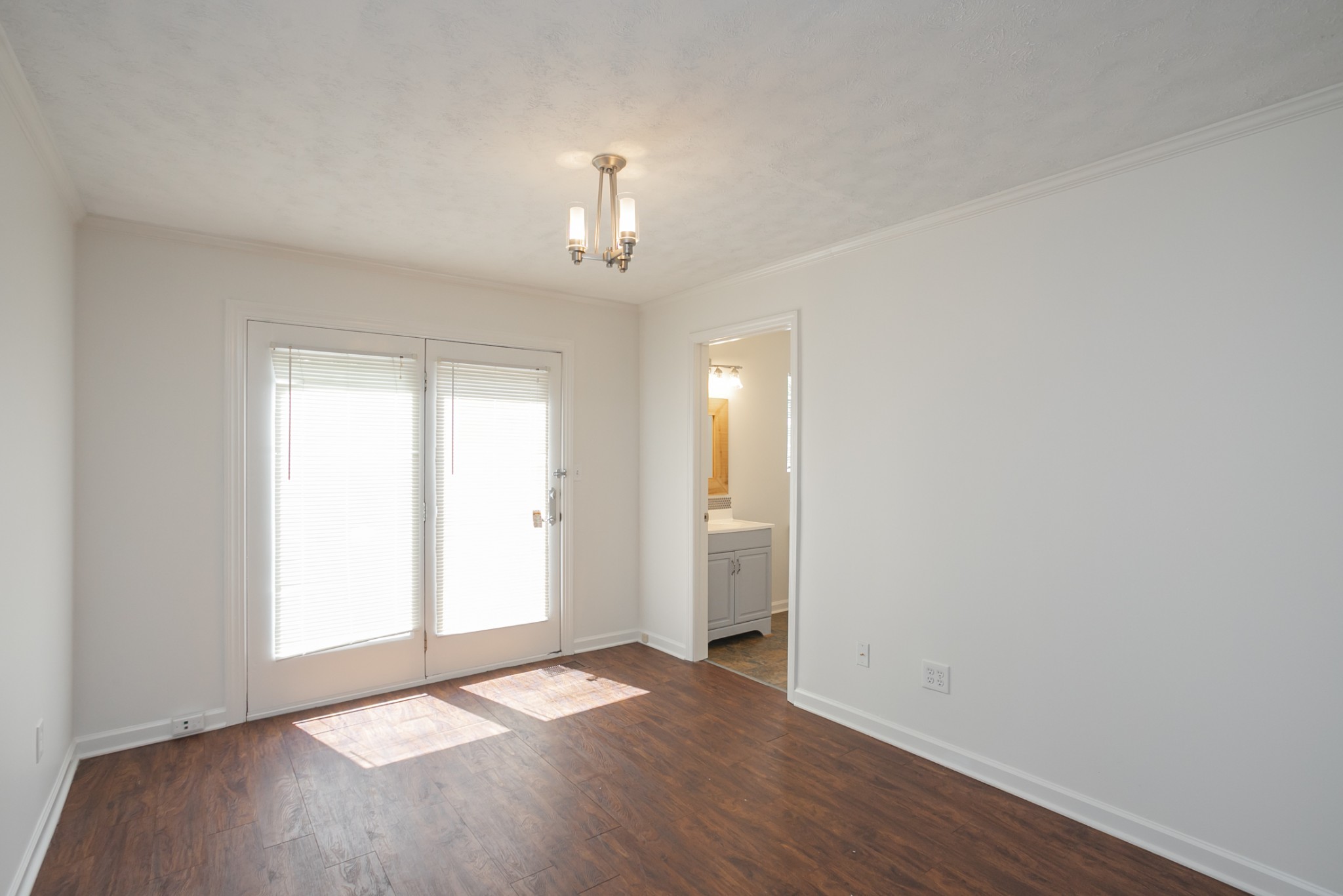 1720 Hanover Road, Unit B Nashville, TN 37216 - Photo 17 of 25 an empty room with wooden floor chandelier and window
