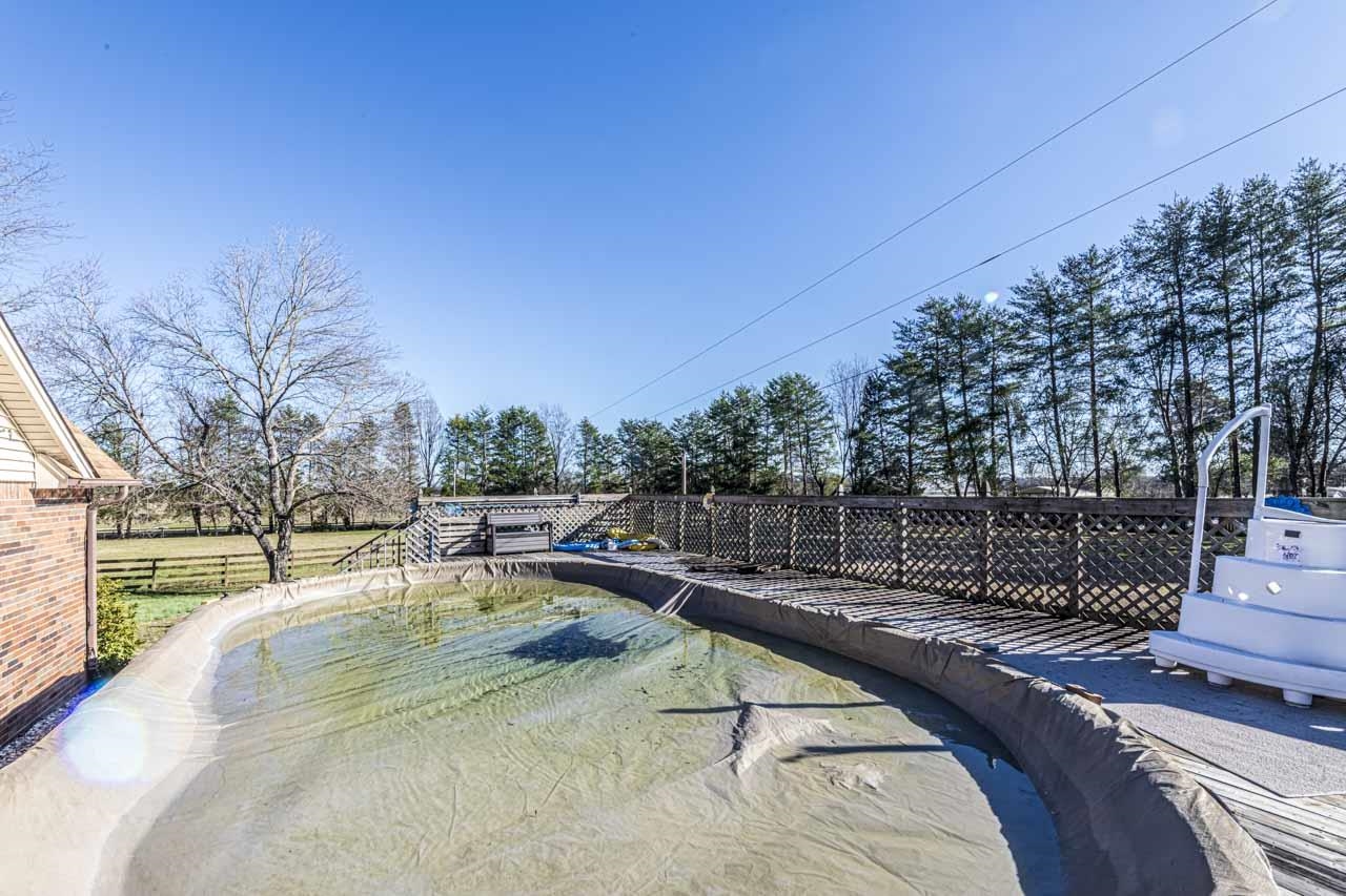 643 Fore Lane Mason, TN 38049 - Photo 27 of 40 a view of a swimming pool with a lounge chair