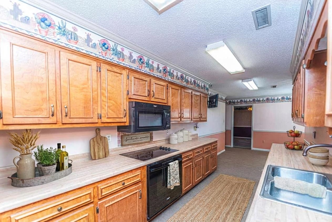 643 Fore Lane Mason, TN 38049 - Photo 7 of 40 a kitchen with stainless steel appliances granite countertop a sink stove and microwave