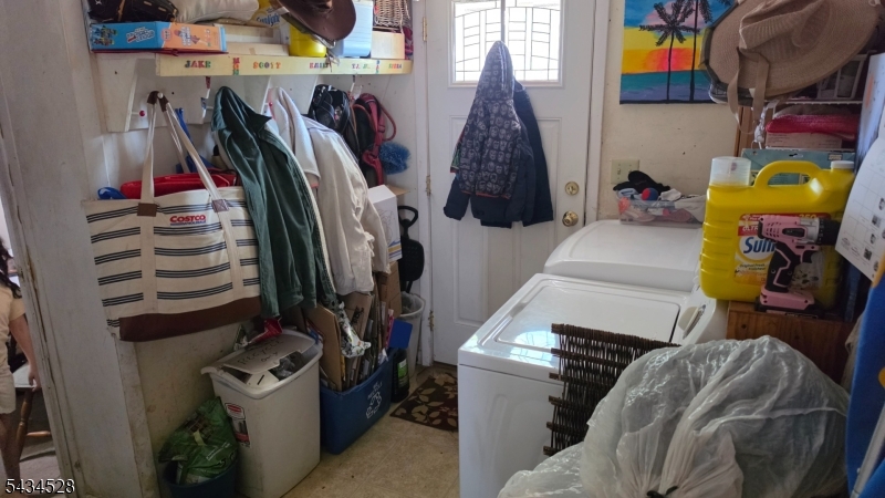 1115 West Camplain Road Manville, NJ 08835 - Photo 10 of 18 a view of walk in closet with clothes and shoes