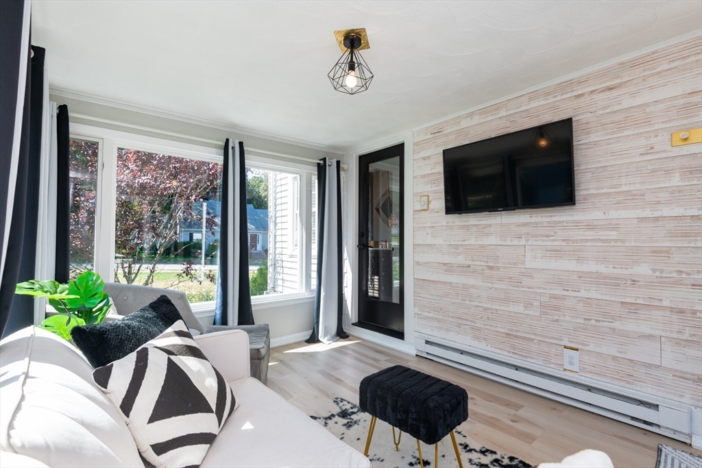 19 Longbow Road Lynnfield, MA 01940 - Photo 12 of 41 a living room with furniture and a flat screen tv