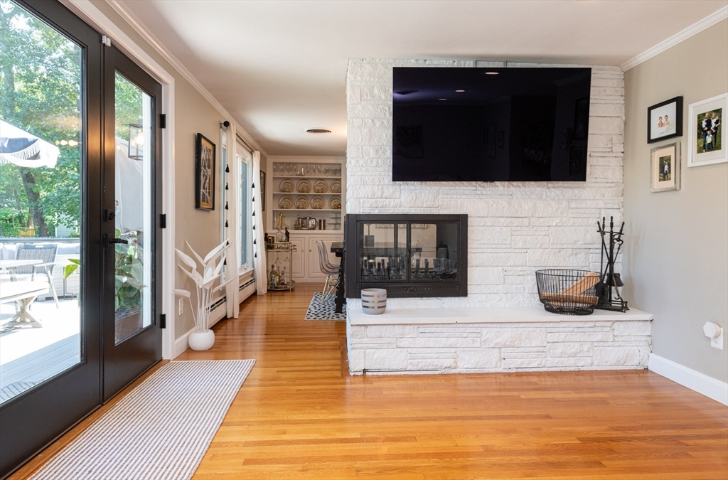 19 Longbow Road Lynnfield, MA 01940 - Photo 20 of 41 a living room with fireplace furniture and a flat screen tv