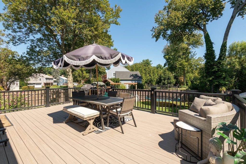 19 Longbow Road Lynnfield, MA 01940 - Photo 36 of 41 a view of a patio with a dining table and chairs with wooden floor and fence