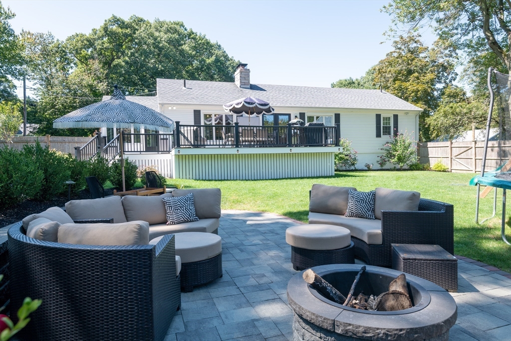 19 Longbow Road Lynnfield, MA 01940 - Photo 37 of 41 a patio with patio a table and chairs and a umbrella