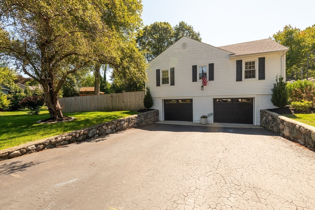 19 Longbow Road Lynnfield, MA 01940 - Photo 4 of 41 a front view of a house with a yard and garage