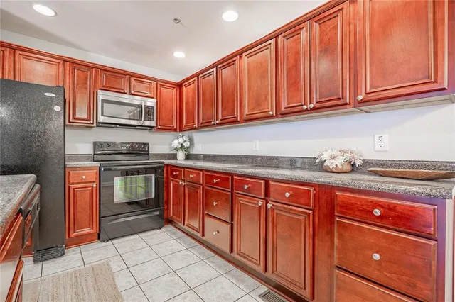 a kitchen with stainless steel appliances granite countertop a sink and a stove