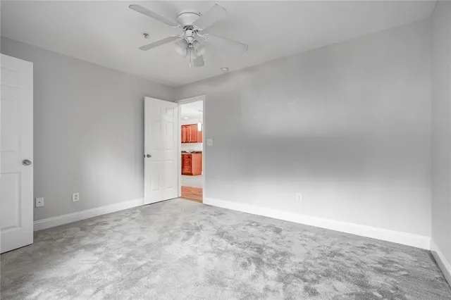 a bathroom with a granite countertop sink a toilet a mirror a bathtub and shower