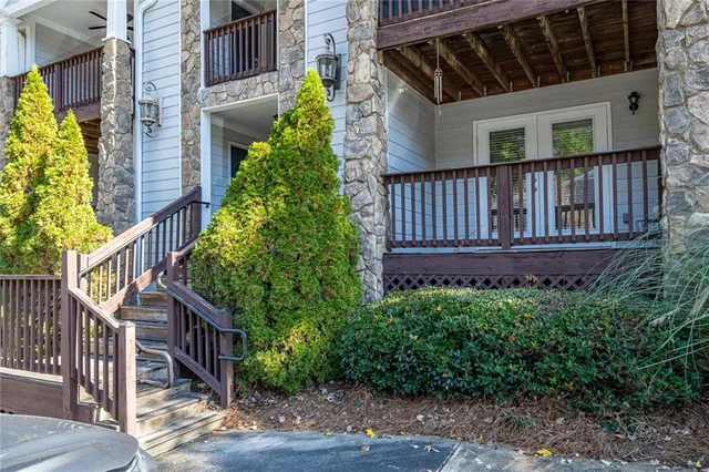 a view of a house with wooden deck front of house