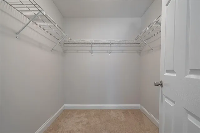 a bathroom with a granite countertop sink a toilet a mirror and shower