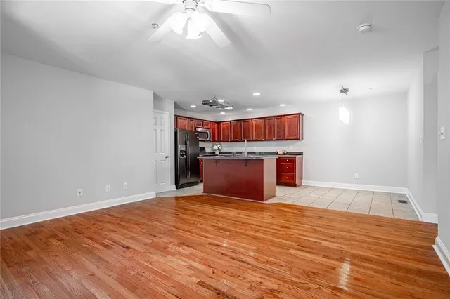 a view of kitchen and kitchen with microwave